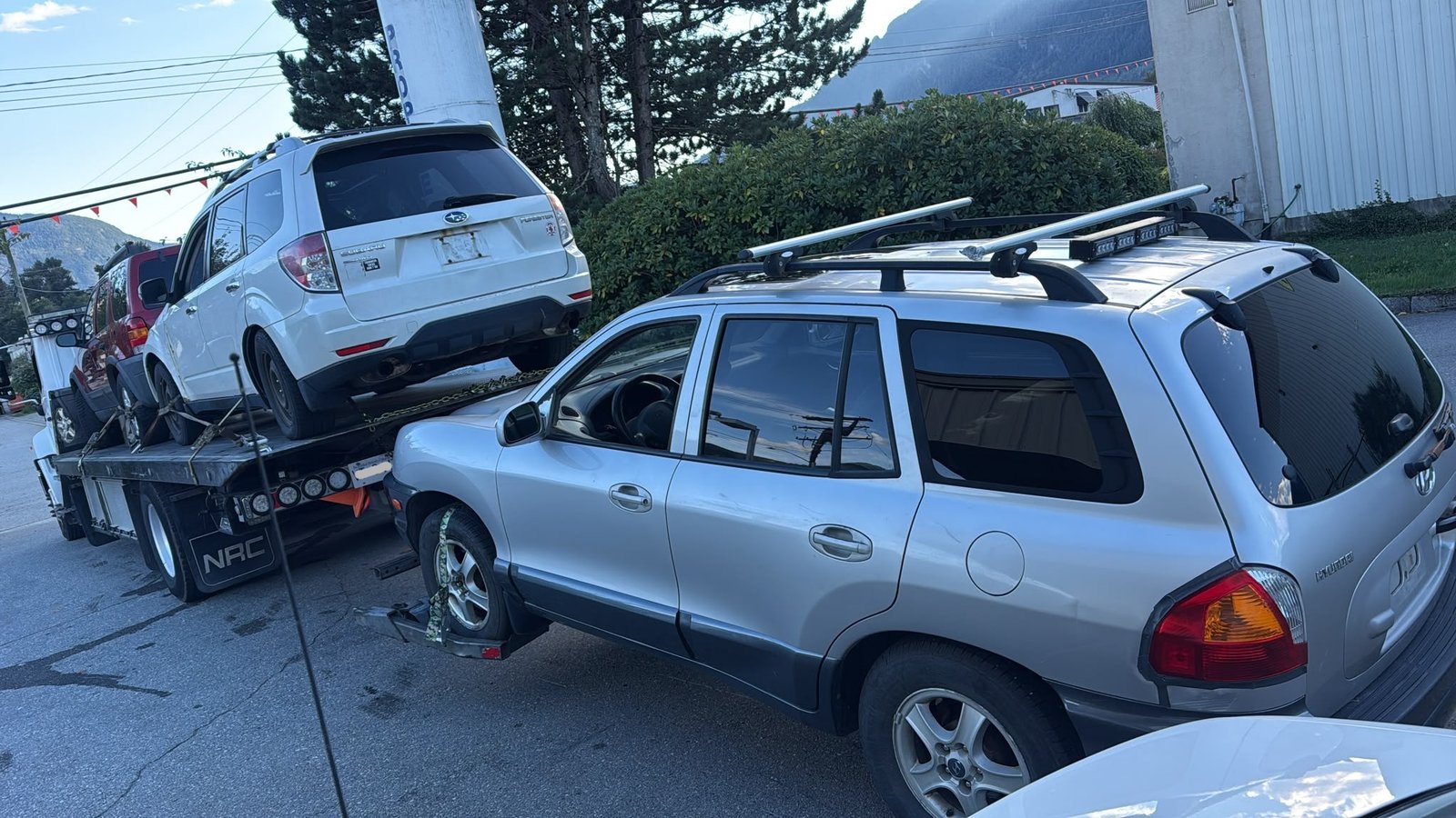 Flatbed loading a scrap car for cash in Langley, Fraser Valley